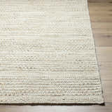 Close-up of the hand woven Moshe Area Rug showing its peach color, wool texture, and farmhouse style. Front