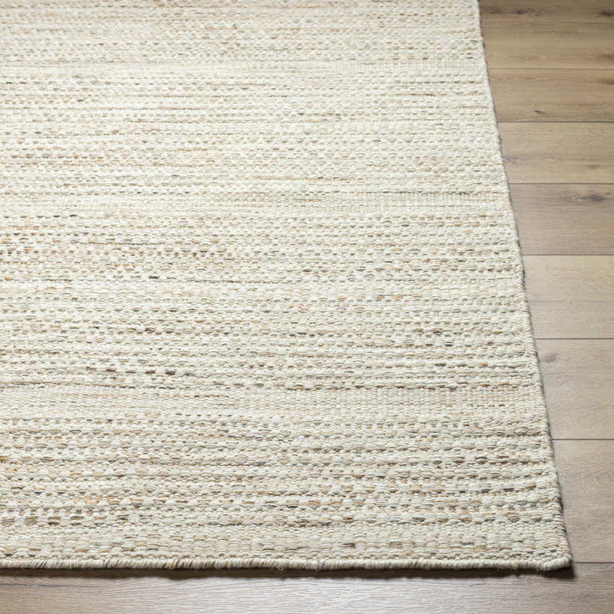 Close-up of the hand woven Moshe Area Rug showing its peach color, wool texture, and farmhouse style. Front