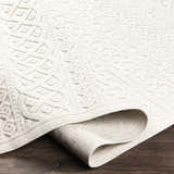 Close-up of the cream Maribyrnong 3D Outdoor Area Rug, showing its geometric design and textured pile. Fold