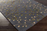 Close-up of the Elsu Brown Beige Wool Rug featuring a floral design with brown branches and beige and green buds. Corner