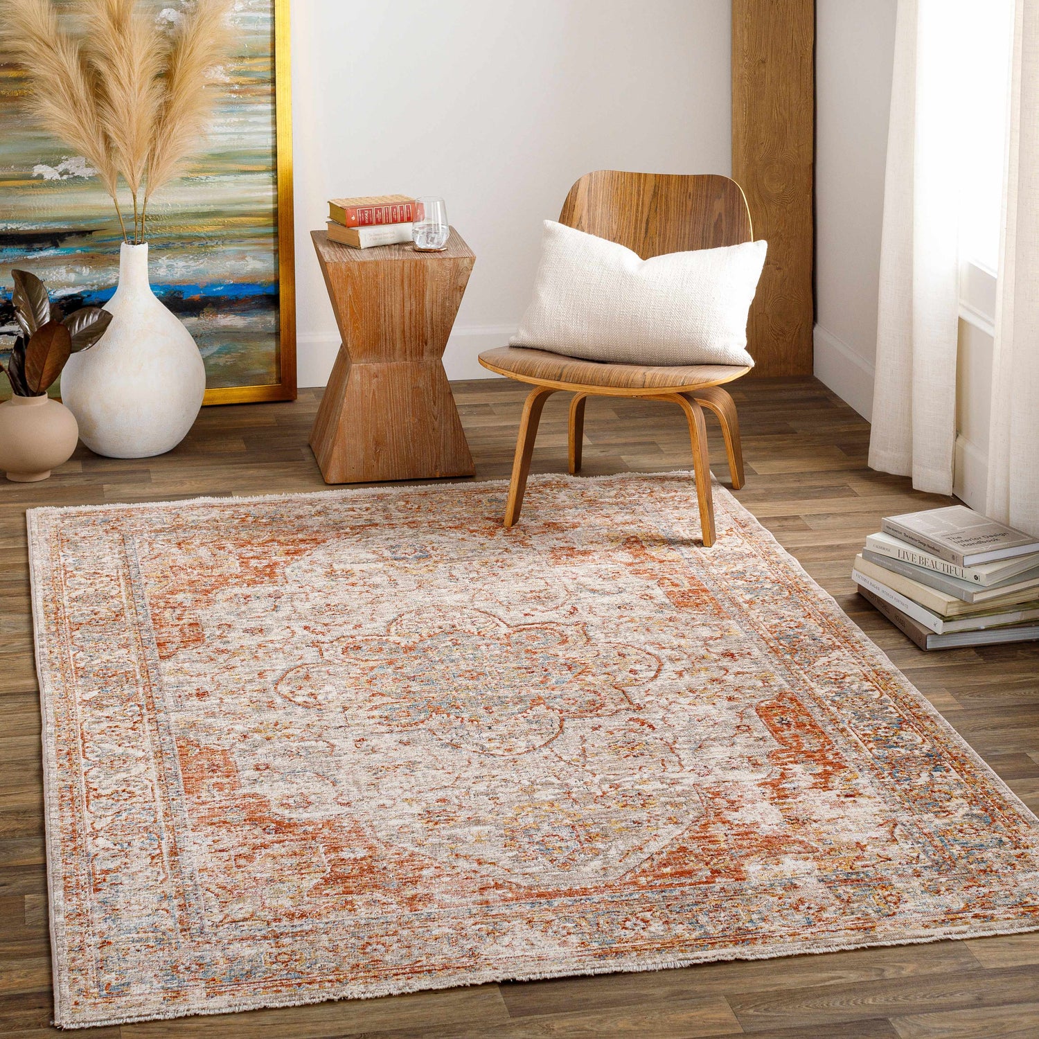 Living room scene with a brick red Marieville Luxe Performance Rug, wood chair, side table, and artwork. Roomscene-Rectangle