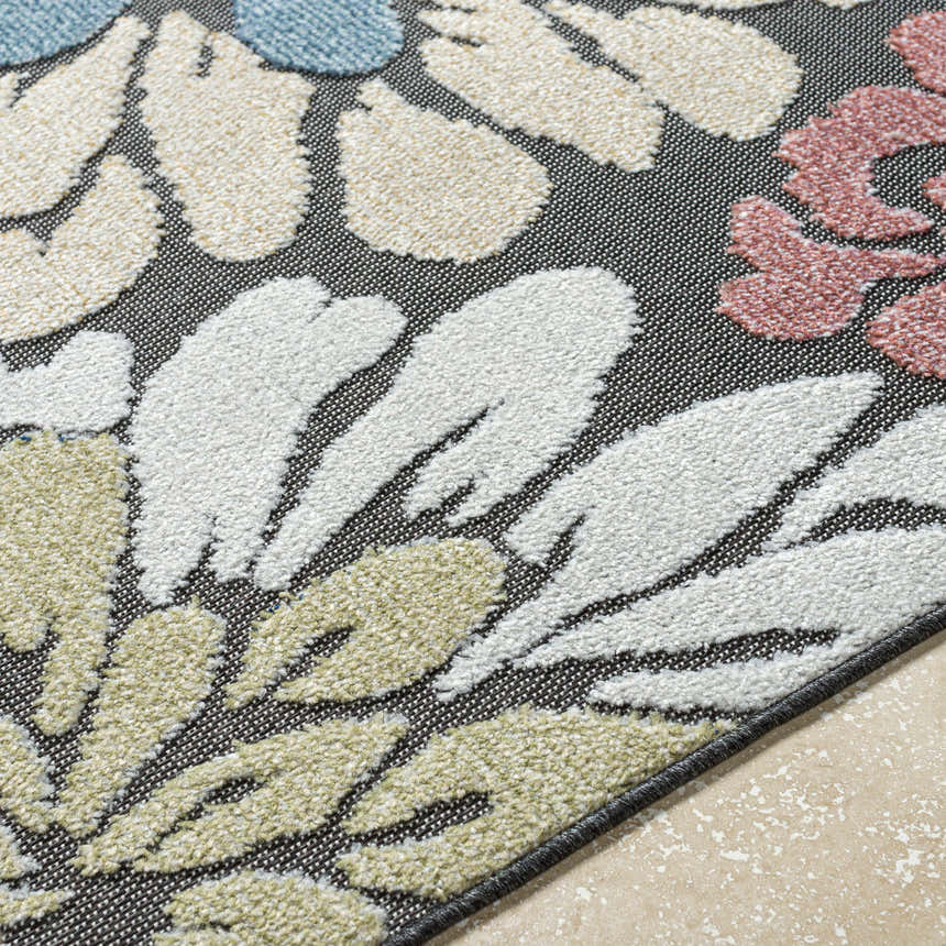 Close up of Minga Charcoal Area Rug showing floral pattern in cream, olive, rust, and navy. Polypropylene texture. Texture