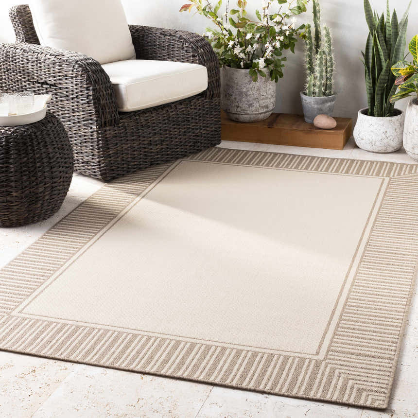 Beige Muncie Area Rug in an outdoor living space with wicker furniture and potted plants. Contemporary farmhouse style. Roomscene-Rectangle
