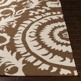 Close-up of the hand woven Naeva Area Rug. Dark brown and walnut floral pattern on a rectangular wool rug. Front