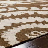 Close-up of the hand woven Naeva Area Rug showing the dark brown and walnut contemporary pattern and wool texture. Texture