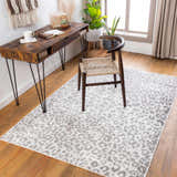 Home office with wood desk, chair, and gray Nagambie Leopard Print Area Rug on hardwood floor. Modern, stylish workspace. Roomscene-Rectangle