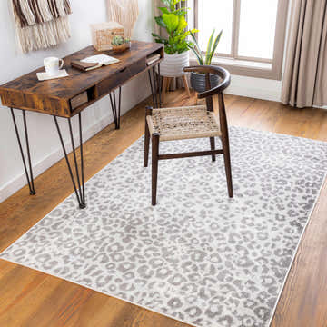 Home office with wood desk, chair, and gray Nagambie Leopard Print Area Rug on hardwood floor. Modern, stylish workspace. Roomscene-Rectangle