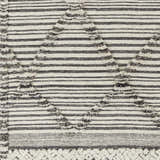 Close-up of the Nairobi Area Rug, a hand-knotted wool rug with black, gray, and ivory stripes and textured diamond accents. Swatch