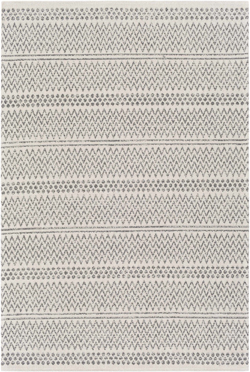 Close-up of Nalcrest Washable Area Rug. Bohemian style rug with charcoal, gray, and white chevron and dot pattern. Design-Rectangle-5373