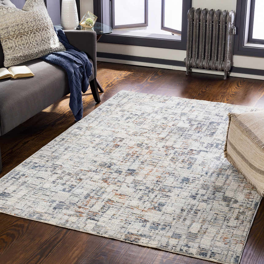 Living room scene with a cream, denim, and brick red Nalus Area Rug, gray sofa, and dark wood floors. Roomscene-Rectangle