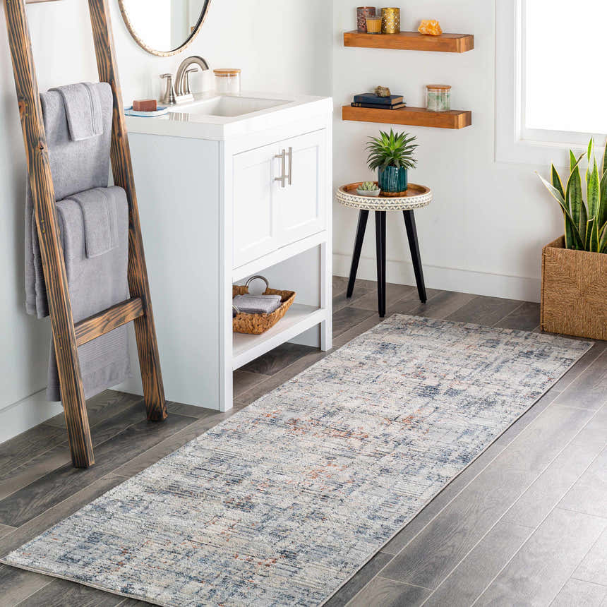 Bathroom scene with a gray Nalus Area Rug runner, white vanity, wood accents, and a plant. Roomscene-Runner