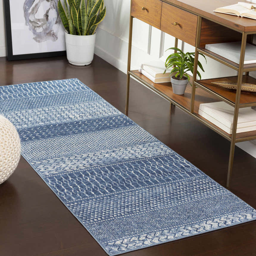 Hallway scene with a denim and ivory Nampa Area Rug runner, wood console table, and modern decor. Roomscene-Runner