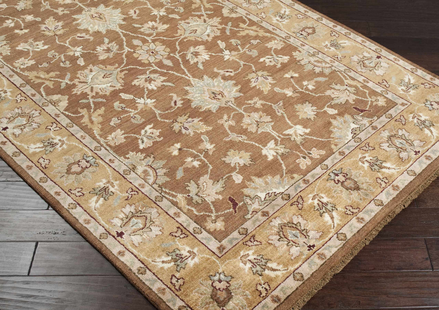 Close-up of the Napolville Premium Wool Area Rug in camel and ivory with a traditional floral pattern. Hand-knotted texture. Corner