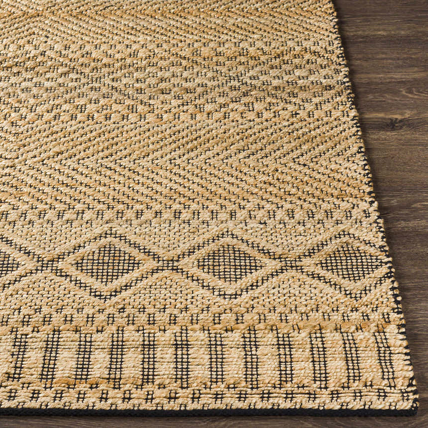 Close-up of the tan and black geometric pattern on the hand woven Nasugbu Jute Carpet. Front