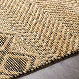 Close-up of the hand woven Nasugbu Jute Carpet. Tan jute rug with a black geometric pattern and natural texture. Texture