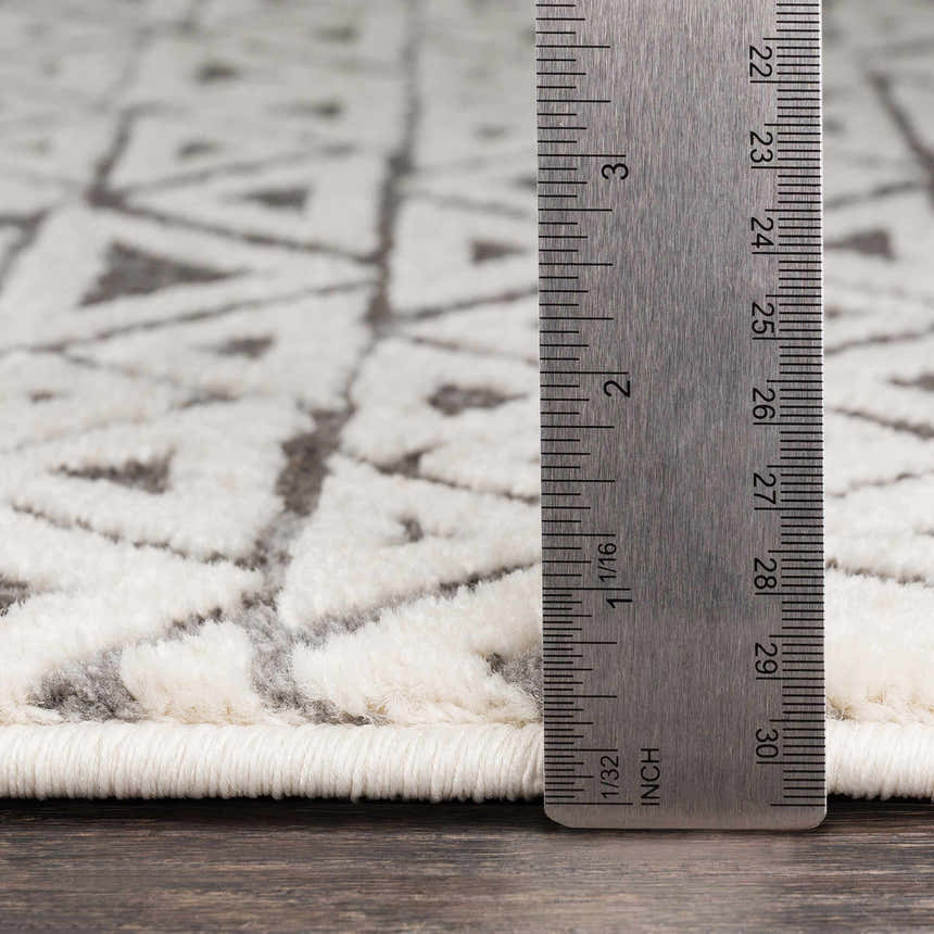 Close up of Naylor Beige/Charcoal Rug showing texture and pile height with a ruler. Farmhouse style rug detail. Pile