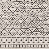 Close-up of Naylor Beige/Charcoal Rug. Features a geometric triangle and circle pattern in neutral beige and charcoal tones. Swatch