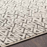 Close up of the Naylor Beige/Charcoal Rug showing the geometric triangle pattern and soft texture. Texture