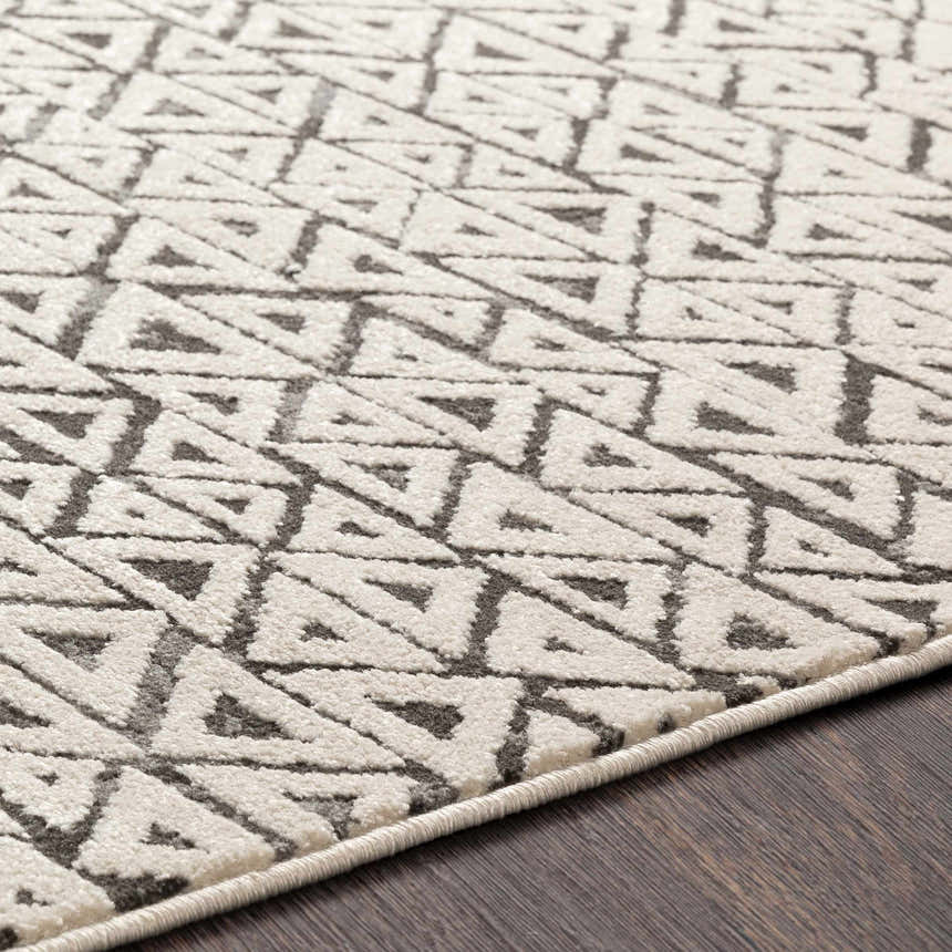 Close up of the Naylor Beige/Charcoal Rug showing the geometric triangle pattern and soft texture. Texture