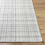 Close-up of the Nissa Blue Gray Checkered Area Rug showing its woven texture and light silver and gray checkered pattern. Front