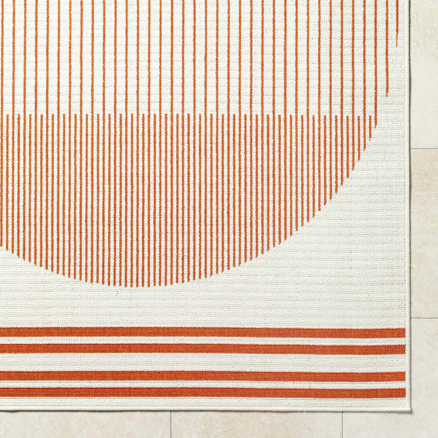 Close up of the Nabil Cream Area Rug featuring an orange striped pattern and cream background. Corner