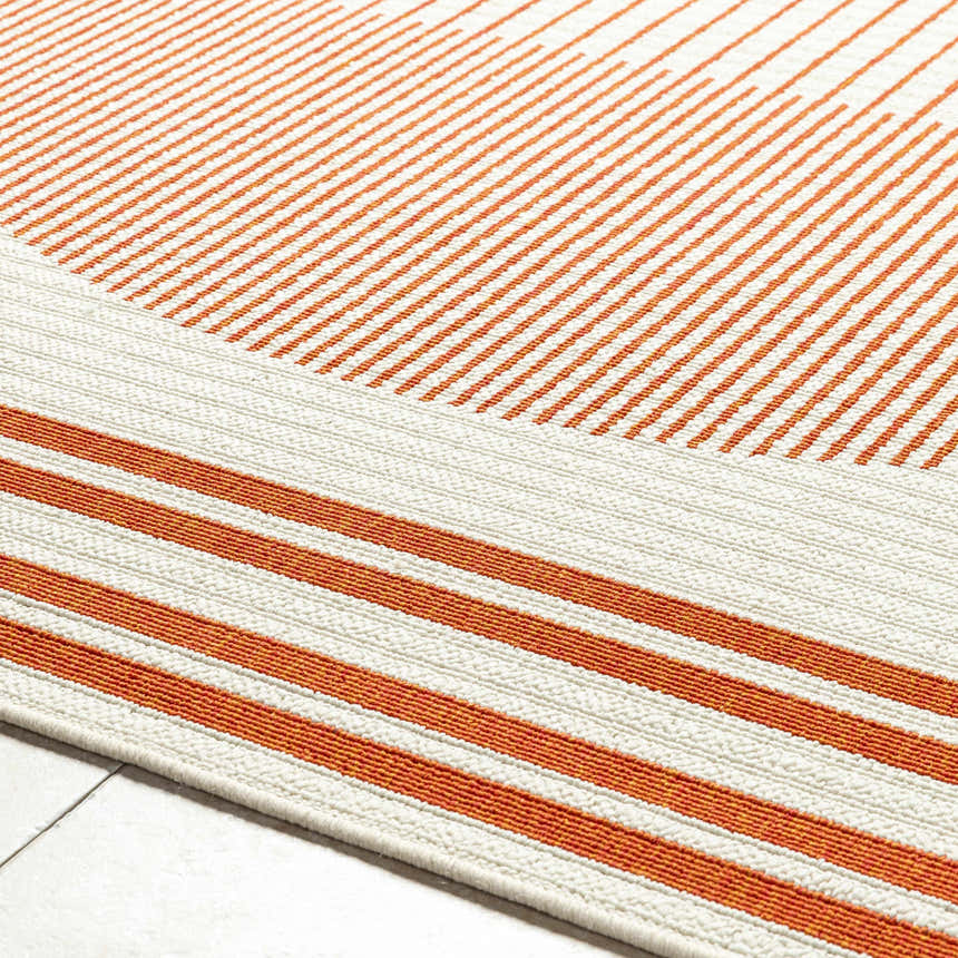 Close up of the Nabil Cream Area Rug showing the cream and orange striped contemporary design. Texture