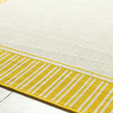Close-up of the Nadir Area Rug; cream rug with yellow and white striped border. Texture