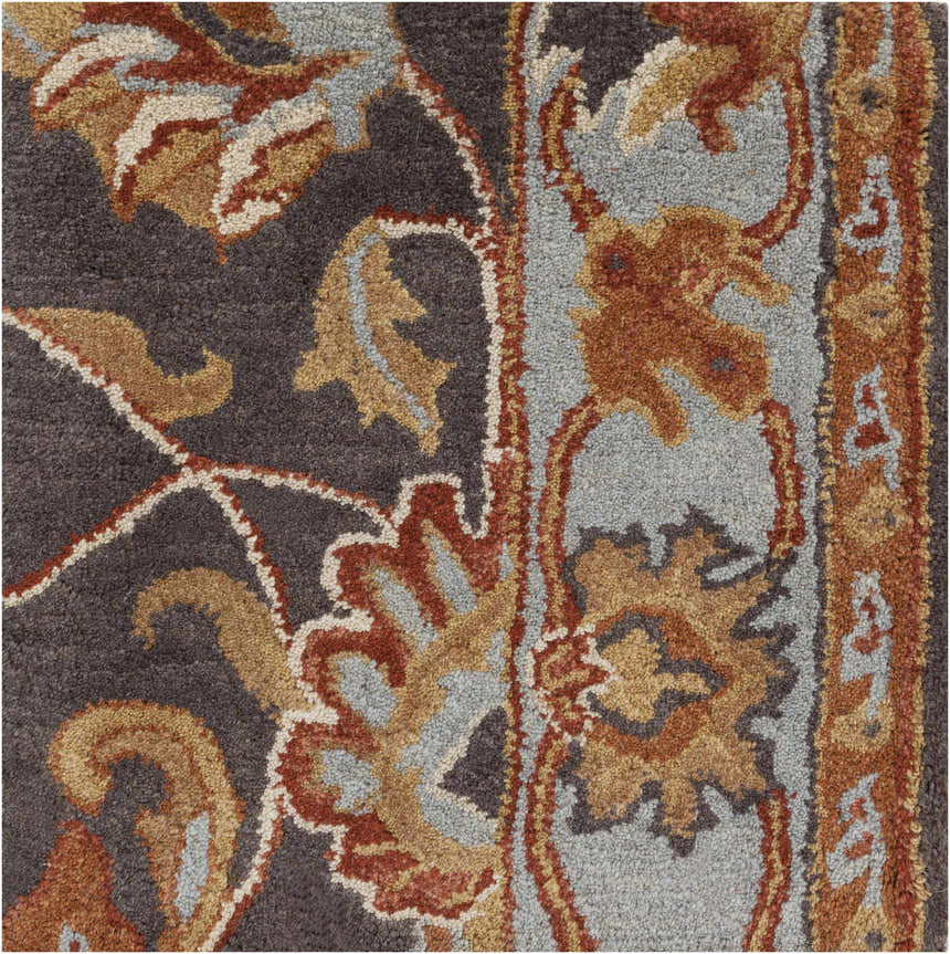 Close-up of the hand-tufted Cherryfield 1004 rug. Wool rug features beige, burnt orange, and charcoal floral pattern. Swatch