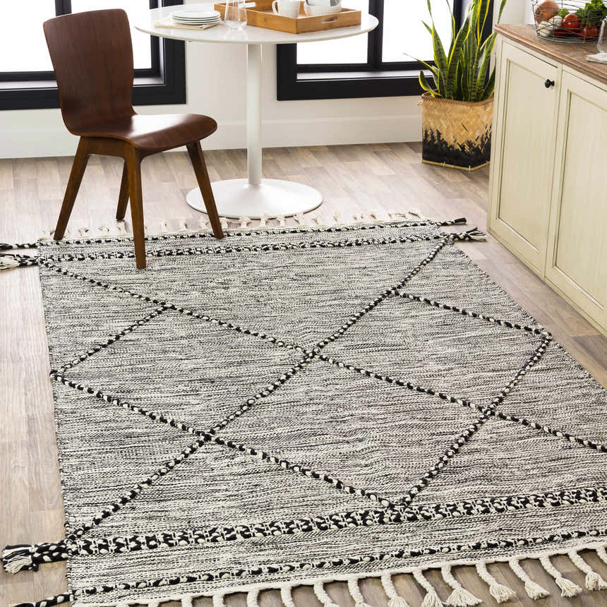 Kitchen scene with Neal Black/Cream Trellis Cotton Rug, white table, wood chair, and light wood cabinets. Roomscene-Rectangle