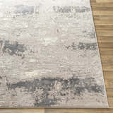 Close-up of the Neponsit Area Rug showing its charcoal, gray, and ivory contemporary design and textured surface. Front