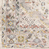 Close-up of the Newkirk Area Rug. Traditional rug pattern in cream, charcoal, brick red, blue, and mustard. Swatch