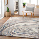 Light and airy room scene with Nillumbik Gray Marble Design Rug, woven chair, and potted plants. Roomscene-Rectangle