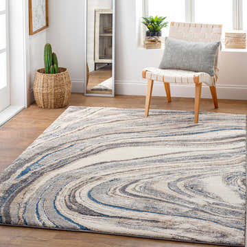 Light and airy room scene with Nillumbik Gray Marble Design Rug, woven chair, and potted plants. Roomscene-Rectangle