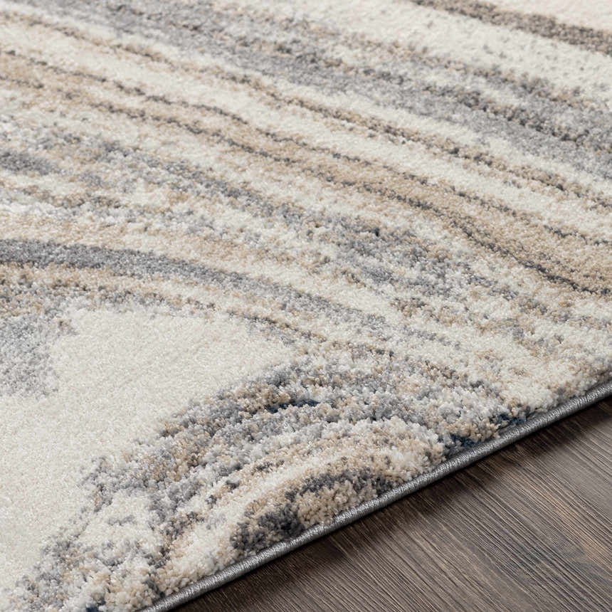 Close-up of the Nillumbik Gray Marble Design Rug, showcasing its charcoal, gray, ivory, and beige swirling pattern and soft texture. Texture