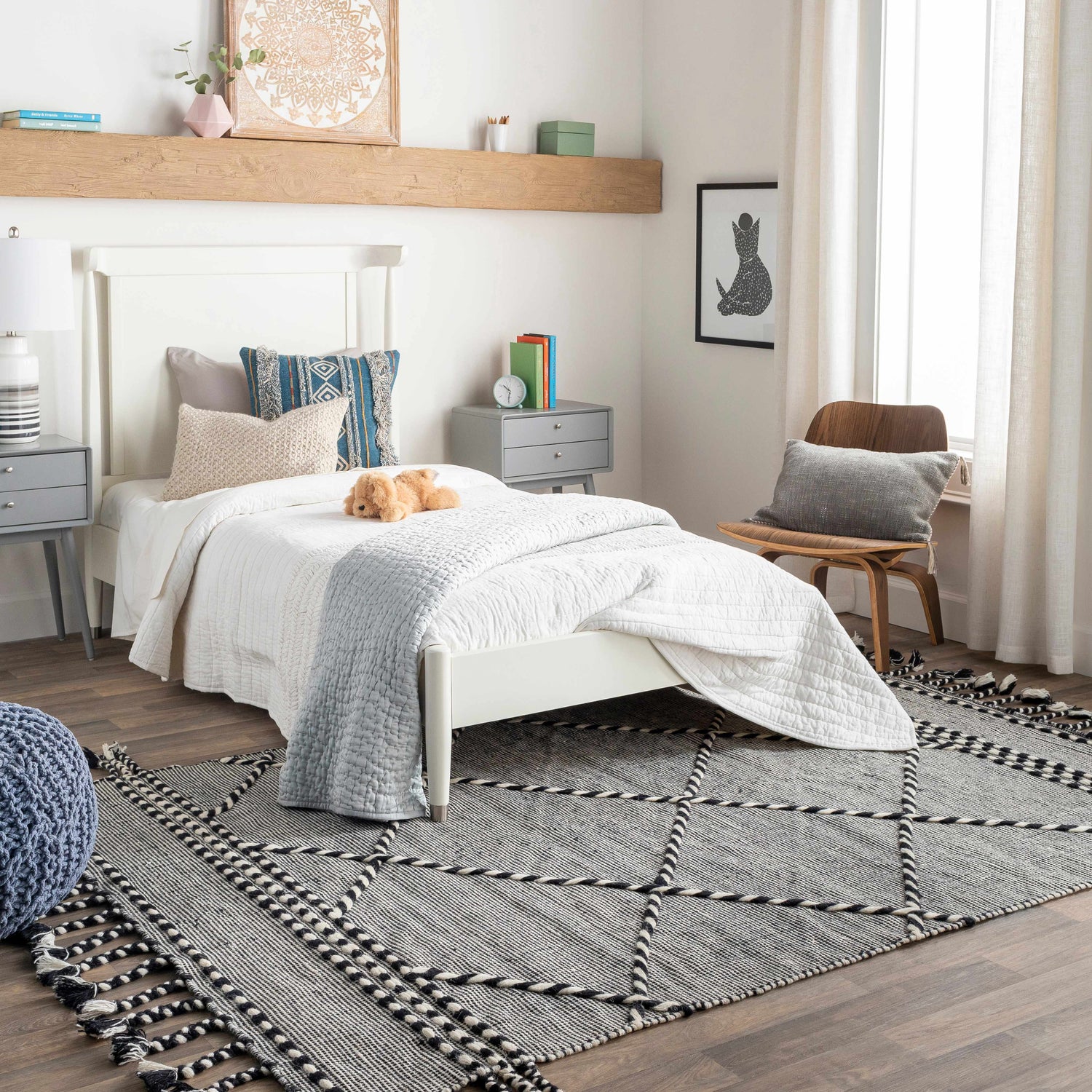 Bedroom scene with a black and cream Ninderry Wool Area Rug, white bed, gray nightstands, and wood accents. Roomscene-Rectangle