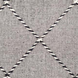 Close-up of the hand-woven Ninderry Wool Area Rug. Black and cream rug with a geometric diamond pattern and textured wool. Swatch