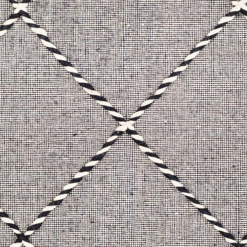 Close-up of the hand-woven Ninderry Wool Area Rug. Black and cream rug with a geometric diamond pattern and textured wool. Swatch
