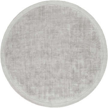Close-up of a round Niota Sheen Light Gray Premium Rug. The hand-loomed rug has a subtle sheen and soft, light gray color. Design-Round-59