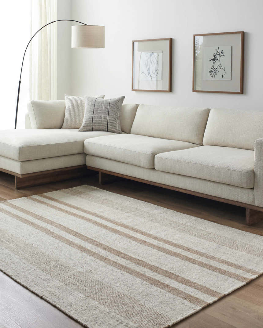 Living room scene with a neutral sofa and the striped Nibaw Area Rug in ash and tan. Roomscene-Rectangle