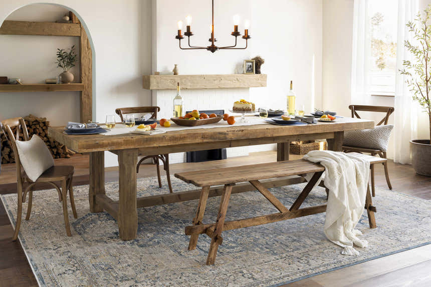 Farmhouse dining room with wood table, bench, and Norland Area Rug in blue, gray, and tan tones. Roomscene-Rectangle