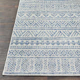 Close-up of the Novato All Over Pattern Performance Rug, showcasing its blue geometric design and woven texture on dark wood floor. Front