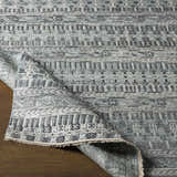 Close-up of the hand-knotted Normanhurst Area Rug showing the charcoal, ivory, light gray, and sage bohemian pattern. Front