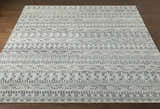 Close-up of the Normanhurst Area Rug showcasing its charcoal, ivory, and sage bohemian-inspired pattern and hand-knotted texture. Front