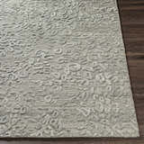 Close-up of the gray Newburn Area Carpet, showcasing its hand-loomed texture and subtle, contemporary pattern. Front