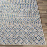 Close up of the Newbern Outdoor Rug showing its blue geometric pattern and woven texture. Front