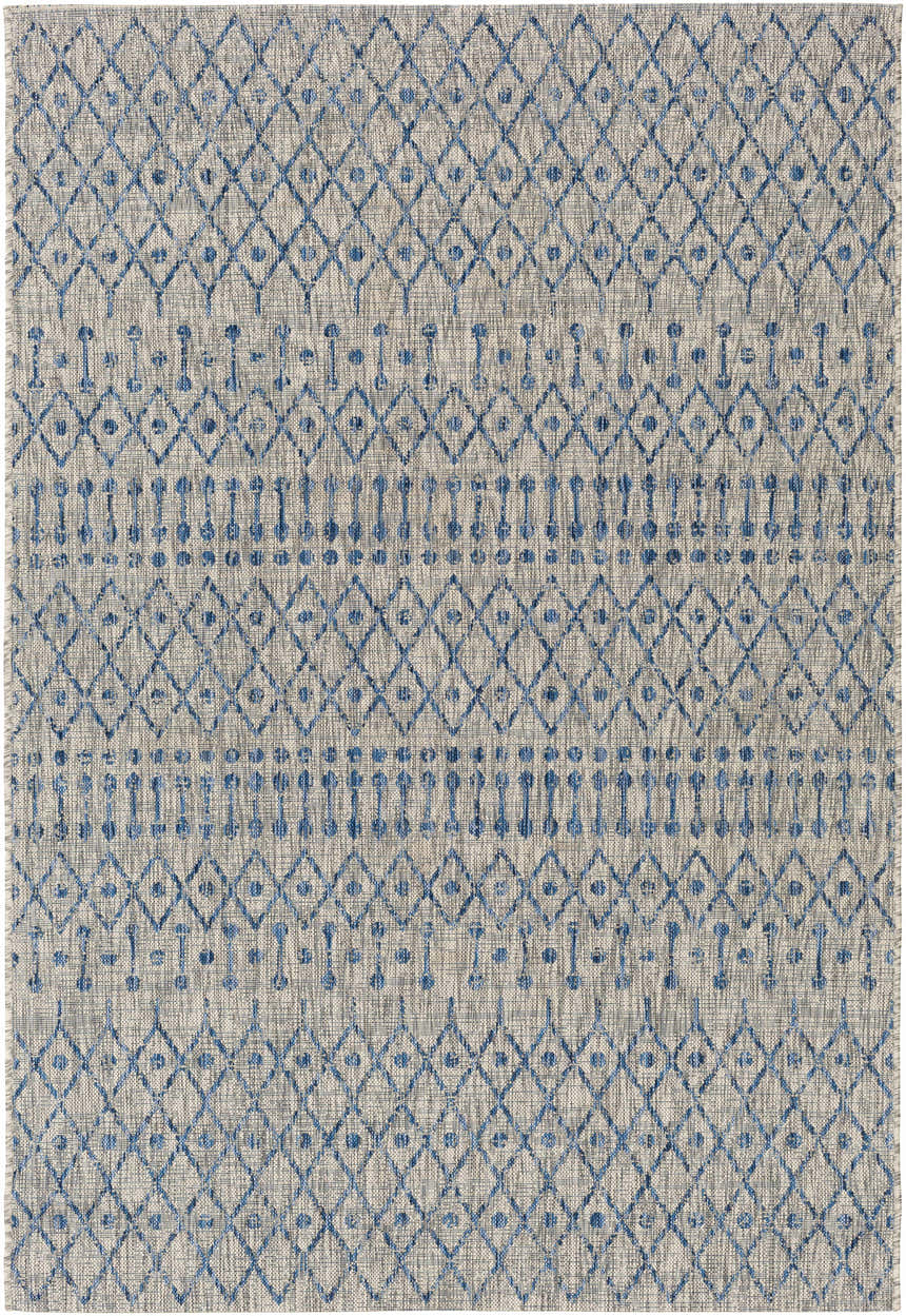 Close-up of the Newbern Outdoor Rug. Bohemian style rug with blue diamond and stripe pattern on a taupe background. Design-Rectangle