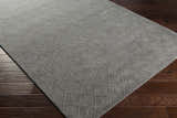 Close up of the charcoal Newtonhill Clearance Rug showing its geometric, hand-loomed design. Corner