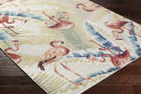 Close-up of Nayan Light Slate Area Rug with a flamingo and palm leaf design in blue, cream, olive, and rust colors. Corner