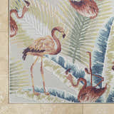 Close-up of Nayan Light Slate Area Rug featuring a flamingo and palm leaf design in blue, cream, and rust tones. Coastal style. Corner