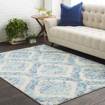 Living room scene with a beige sofa and Oaklyn Teal Floral Diamonds Rug on dark wood floors. Roomscene-Rectangle